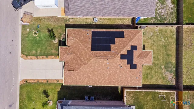 an aerial view of a house with a yard