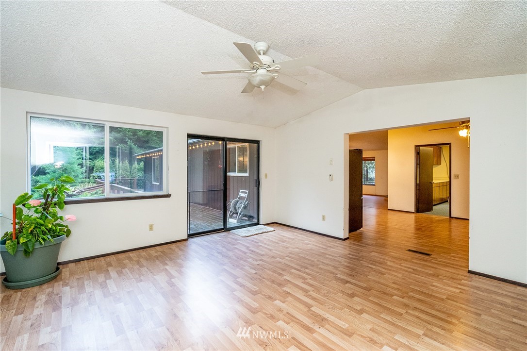 191 Tingle Road Winlock, WA 98596 - Photo 12 of 39 a view of an empty room with wooden floor and a window