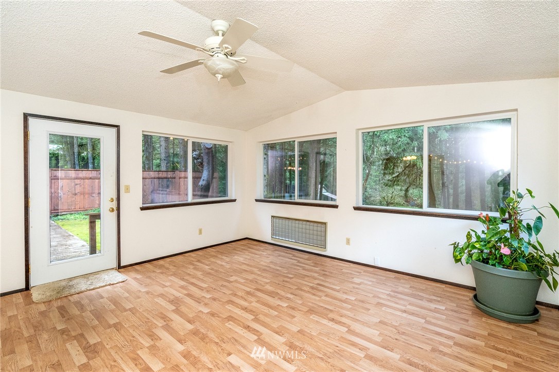 191 Tingle Road Winlock, WA 98596 - Photo 14 of 39 a view of an empty room with a window and wooden floor