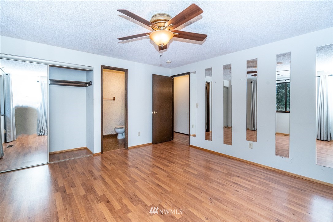 191 Tingle Road Winlock, WA 98596 - Photo 15 of 39 a view of an empty room with window and wooden floor