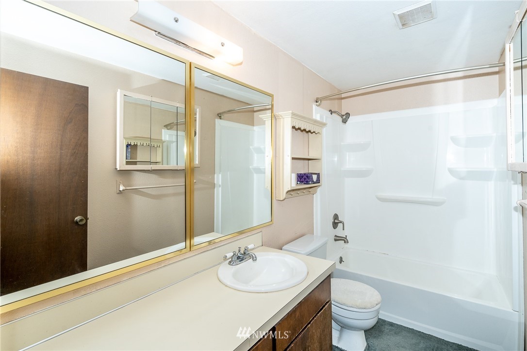 191 Tingle Road Winlock, WA 98596 - Photo 20 of 39 a bathroom with a granite countertop sink toilet and shower
