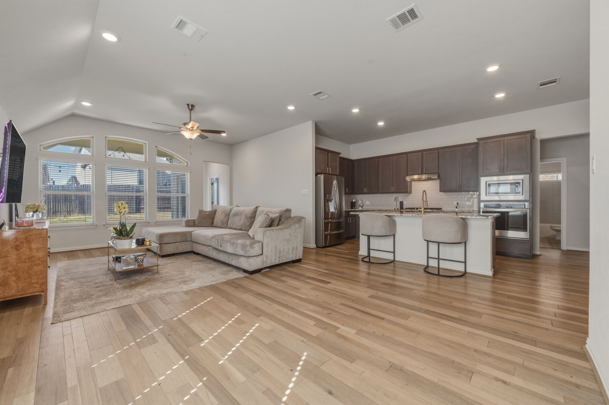 918 Leadtree Loop Buda, TX 78610 - Photo 20 of 27 Living room featuring ceiling fan, recessed lighting, and light wood-style floors