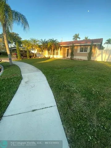 a view of a big yard with palm trees