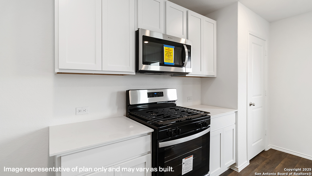 12548 Spoor Valley Converse, TX 78109 - Photo 6 of 50 a kitchen with a stove and a microwave