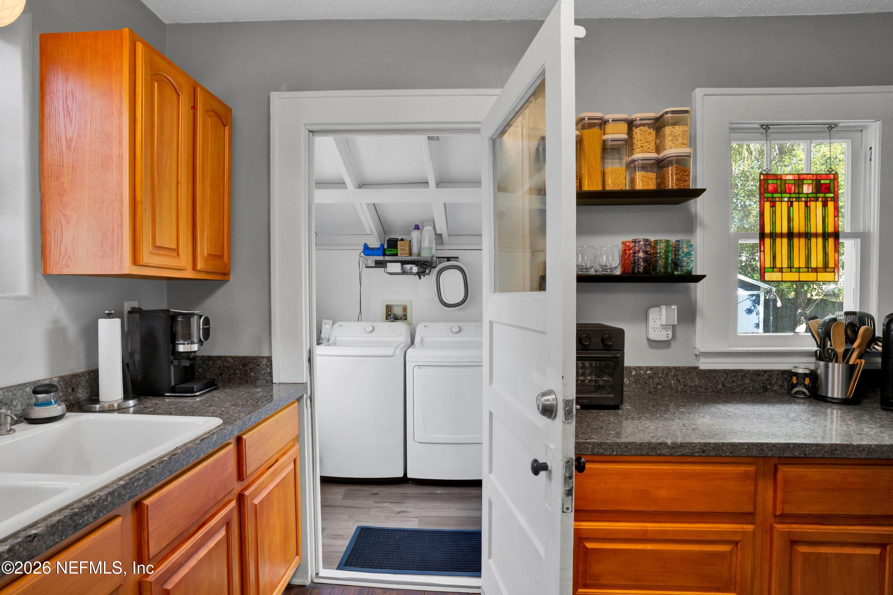 1273 Dancy Street Jacksonville, FL 32205 - Photo 16 of 30 a kitchen with a sink cabinets and window