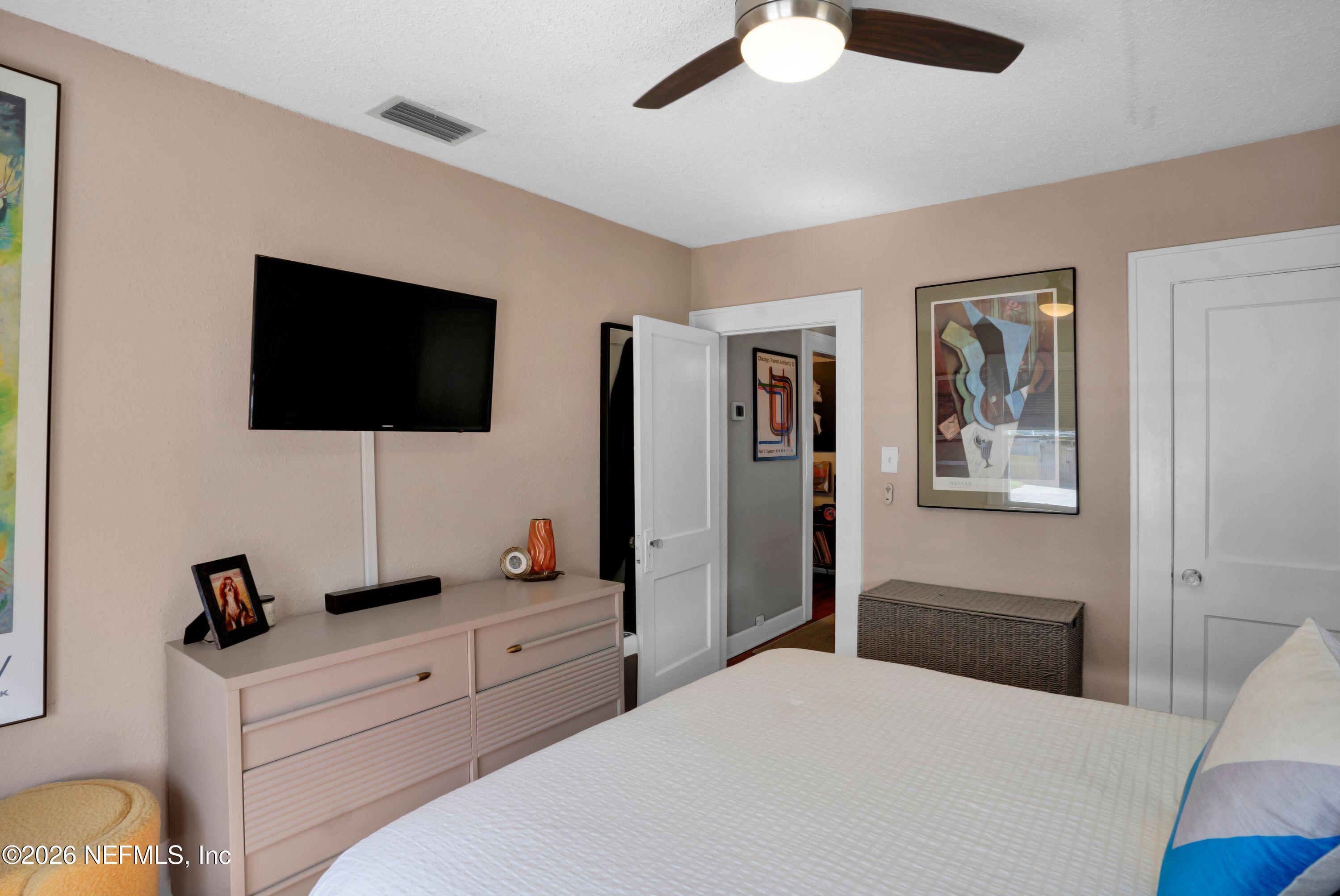 1273 Dancy Street Jacksonville, FL 32205 - Photo 19 of 30 a bedroom with a bed and a flat screen tv