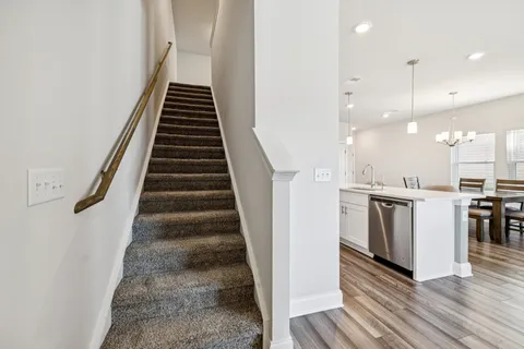 a view of a kitchen with wooden floor and electronic appliances
