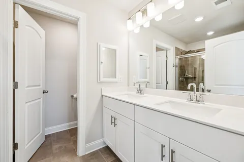 a bathroom with a sink vanity granite and a mirror