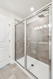 a bathroom with a glass shower door