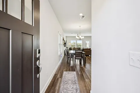 a view of a hallway with a tables and chairs