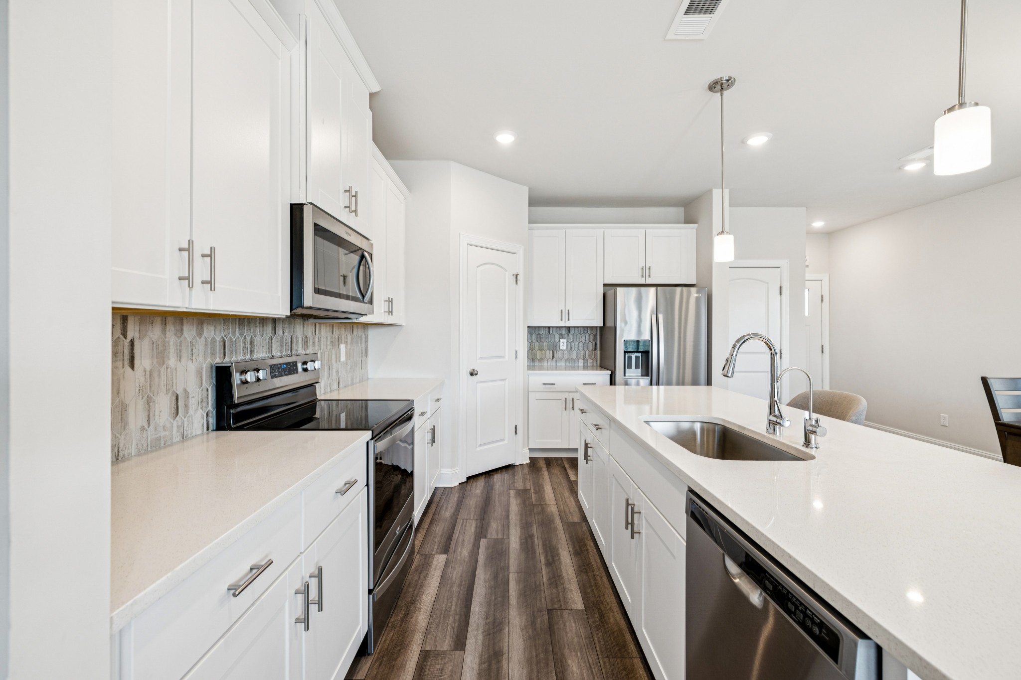 359 Coleman Court Columbia, TN 38401 - Photo 8 of 24 a kitchen with stainless steel appliances a sink a stove top oven a refrigerator a counter top space and cabinets