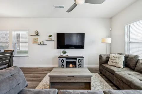 a living room with furniture and a flat screen tv
