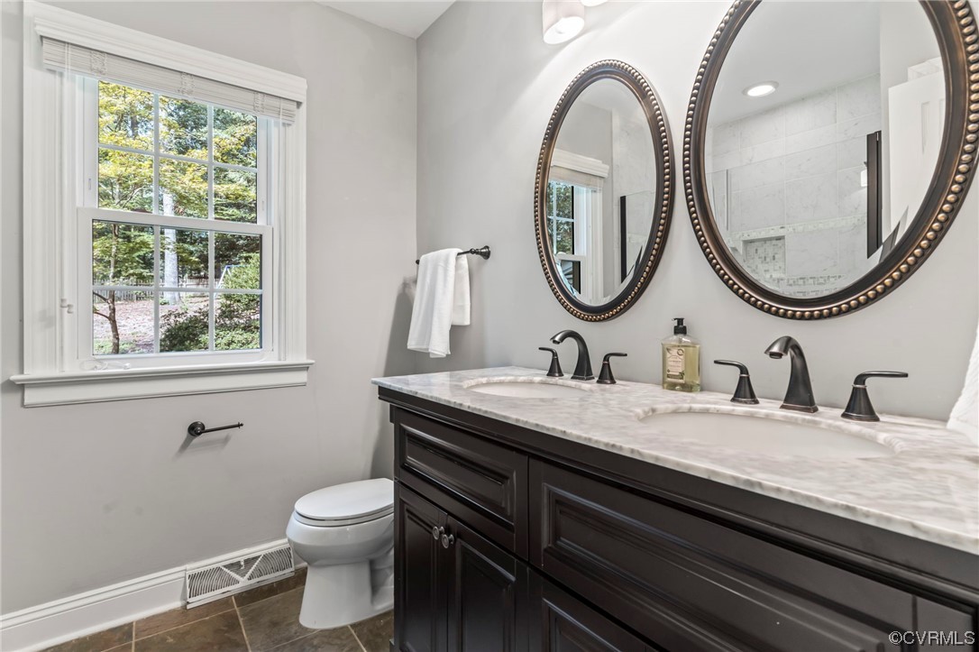 2320 Dorking Road North Chesterfield, VA 23236 - Photo 17 of 42 a bathroom with a granite countertop toilet a sink and a mirror