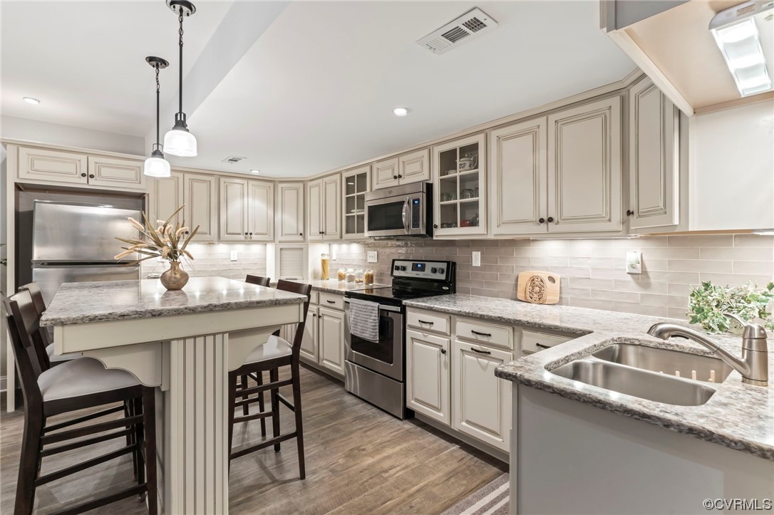 2320 Dorking Road North Chesterfield, VA 23236 - Photo 30 of 42 a kitchen with stainless steel appliances granite countertop a sink a stove a refrigerator cabinets and chairs
