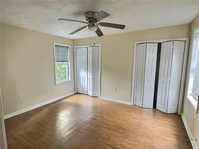 a view of a livingroom with a ceiling fan and window