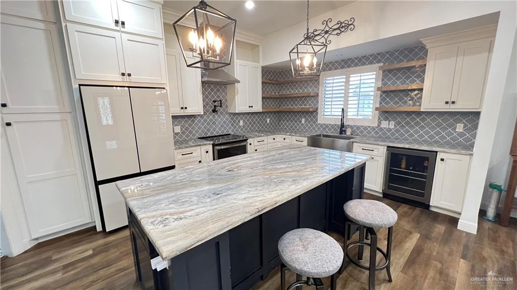 433 Redbud Avenue McAllen, TX 78504 - Photo 3 of 11 a kitchen with granite countertop a table chairs stove refrigerator and cabinets