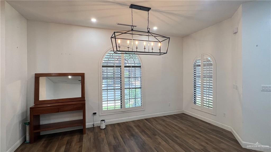 433 Redbud Avenue McAllen, TX 78504 - Photo 4 of 11 wooden floor in an empty room with a window