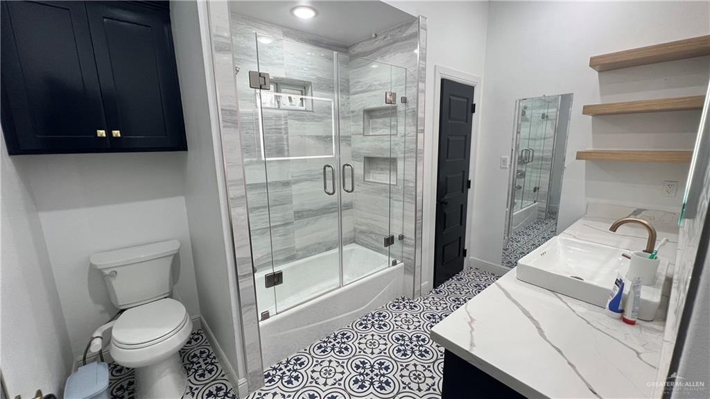 433 Redbud Avenue McAllen, TX 78504 - Photo 9 of 11 a bathroom with a sink toilet and shower