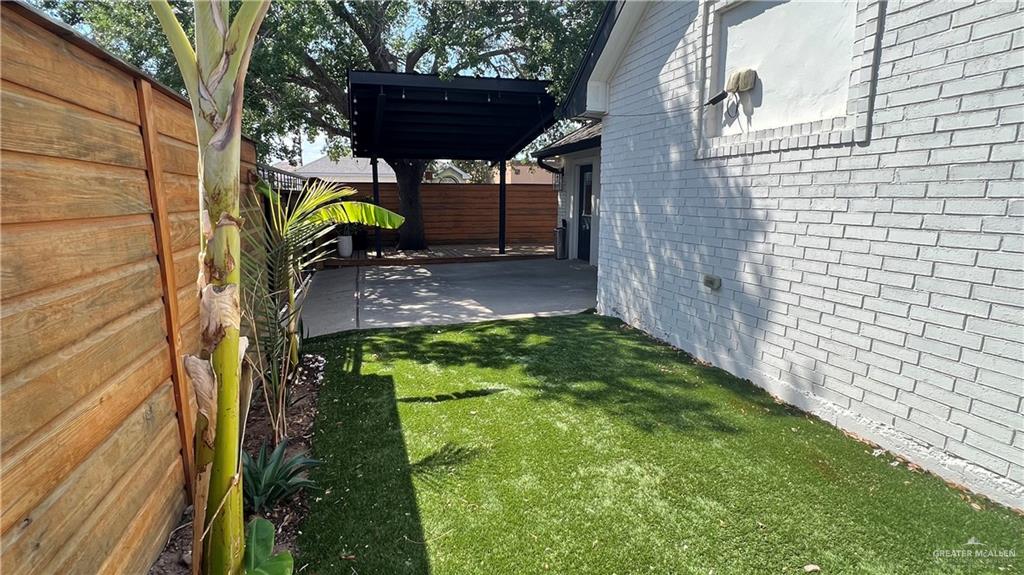 433 Redbud Avenue McAllen, TX 78504 - Photo 10 of 11 a backyard of a house with a table and chairs
