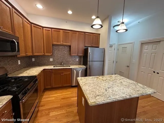 a kitchen with refrigerator cabinets and wooden floor