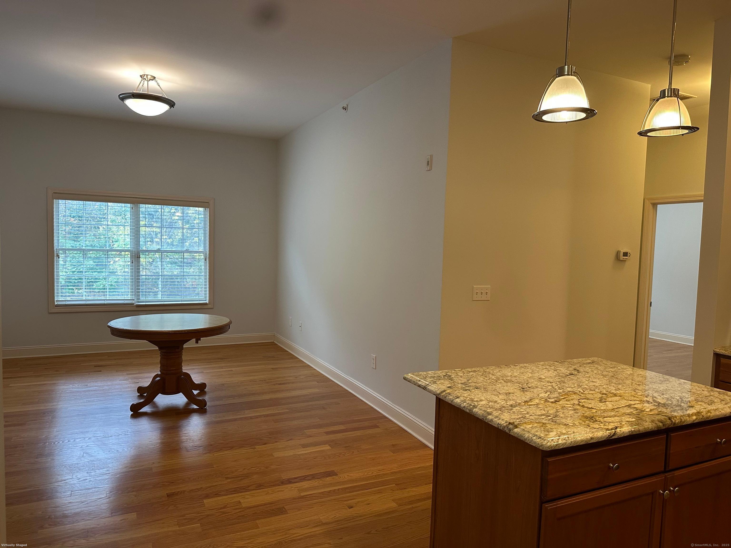 2518 Whitney Avenue, Unit 3 Hamden, CT 06518 - Photo 3 of 14 a kitchen that has a table and a stove