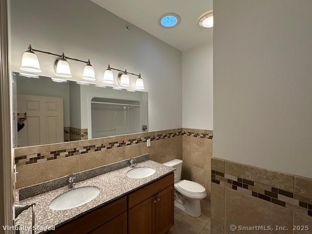 2518 Whitney Avenue, Unit 3 Hamden, CT 06518 - Photo 7 of 14 a bathroom with a granite countertop sink toilet and mirror