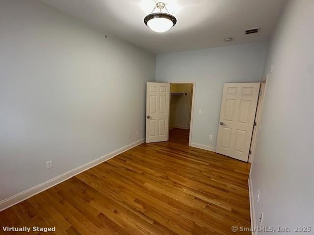 2518 Whitney Avenue, Unit 3 Hamden, CT 06518 - Photo 8 of 14 a view of empty room with wooden floor