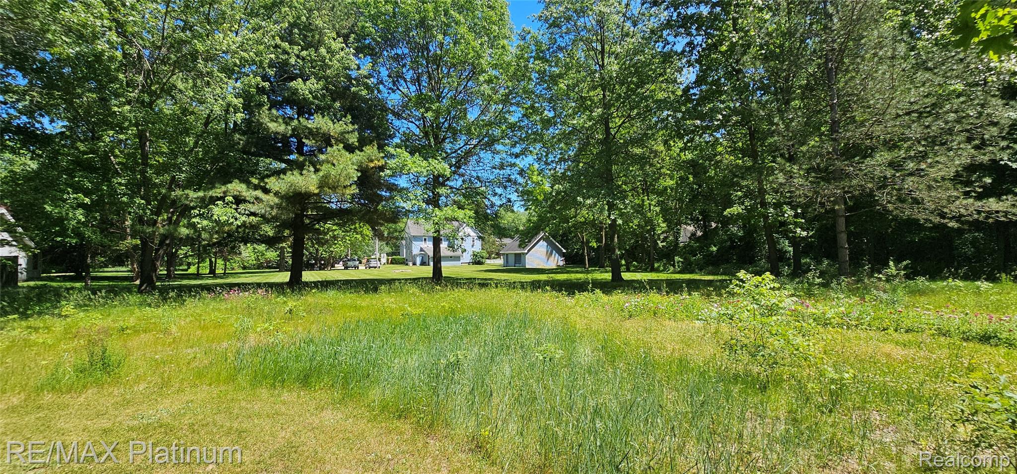 17140 Haggerty Road Belleville, MI 48111 - Photo 35 of 42 Expansive grassy area featuring mature trees and distant structures