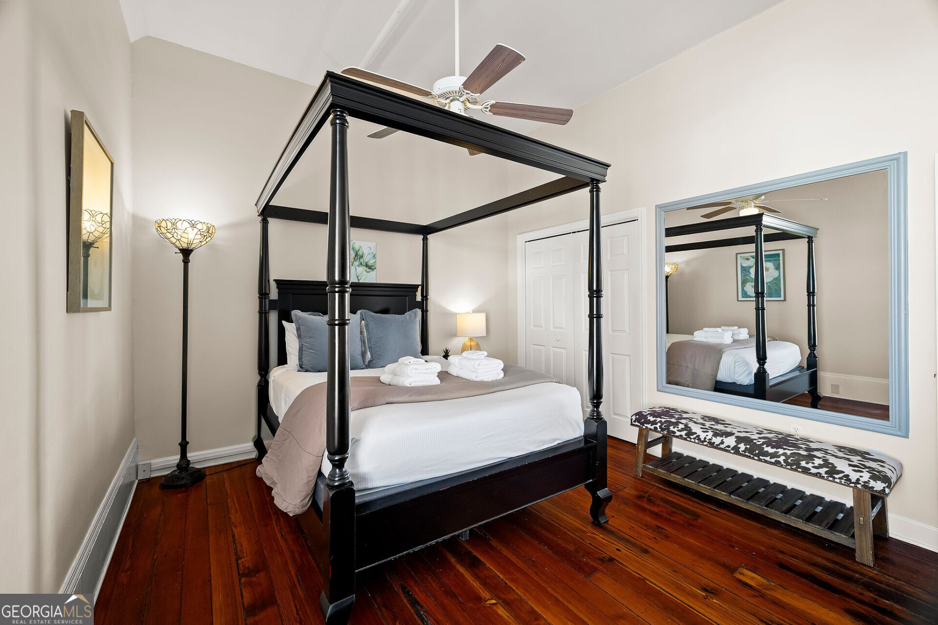 105 Whitaker Street, Unit 302 Savannah, GA 31401 - Photo 17 of 39 a bedroom with a bed and a mirror