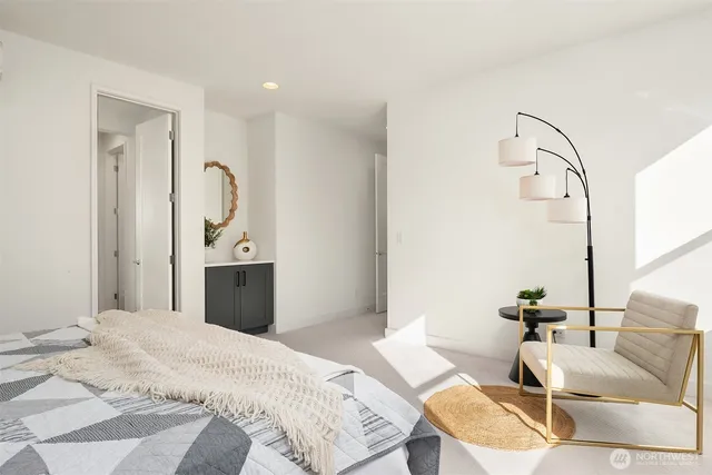 a bedroom with a bed couch and a window