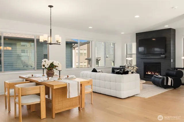a living room with furniture a fireplace and a chandelier