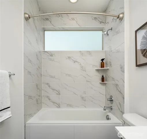 a bathroom with a shower and a bath tub