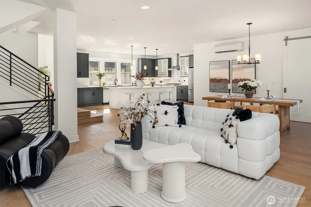 a living room with furniture and view of kitchen