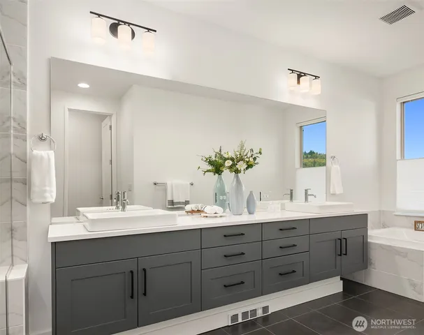 a bathroom with a double vanity sink mirror and double
