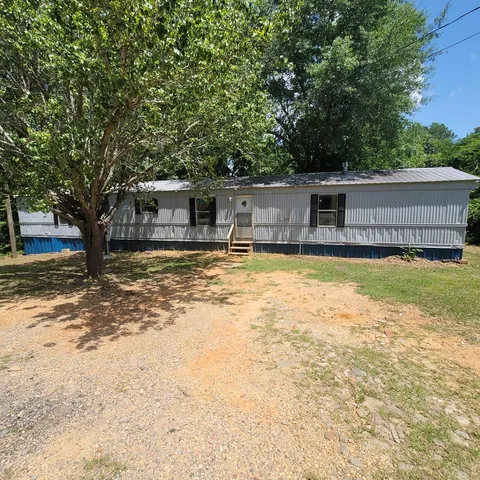 a view of a house with swimming pool and sitting area