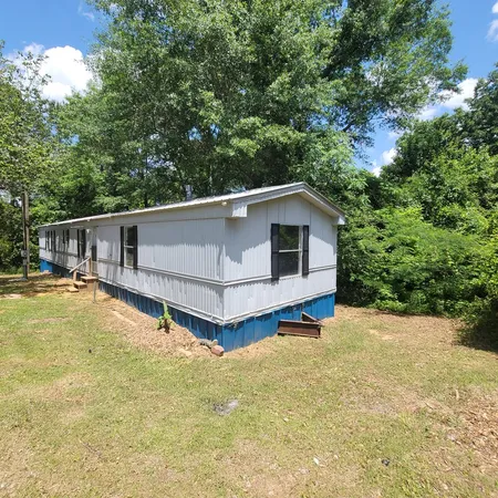 a view of a house with pool and sitting area
