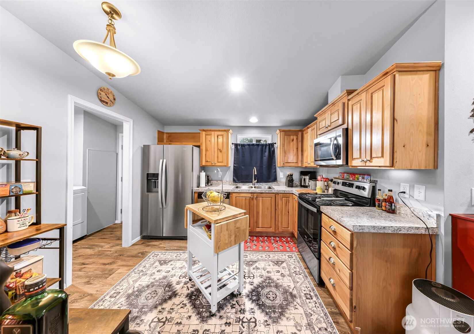 2392 Douglas Road, Unit 57 Ferndale, WA 98248 - Photo 11 of 26 a room with stainless steel appliances a rug kitchen view and a window