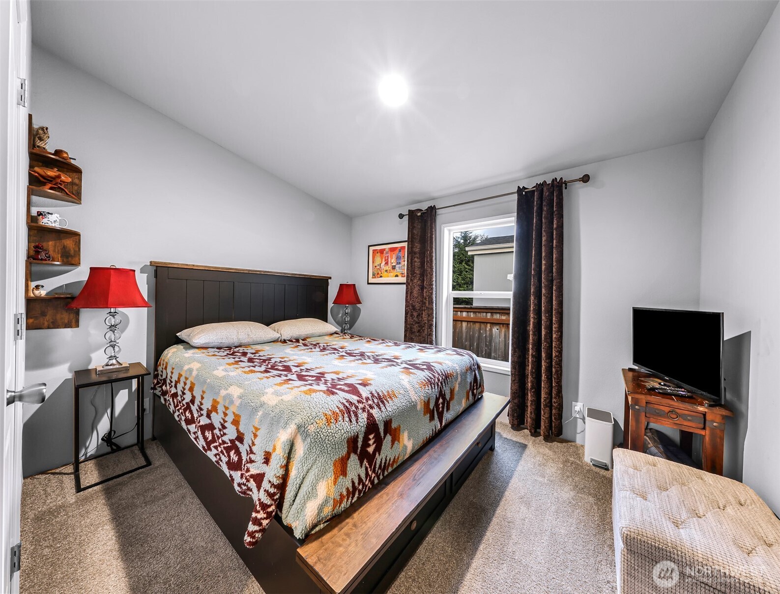 2392 Douglas Road, Unit 57 Ferndale, WA 98248 - Photo 15 of 26 a bedroom with a large bed and a flat screen tv