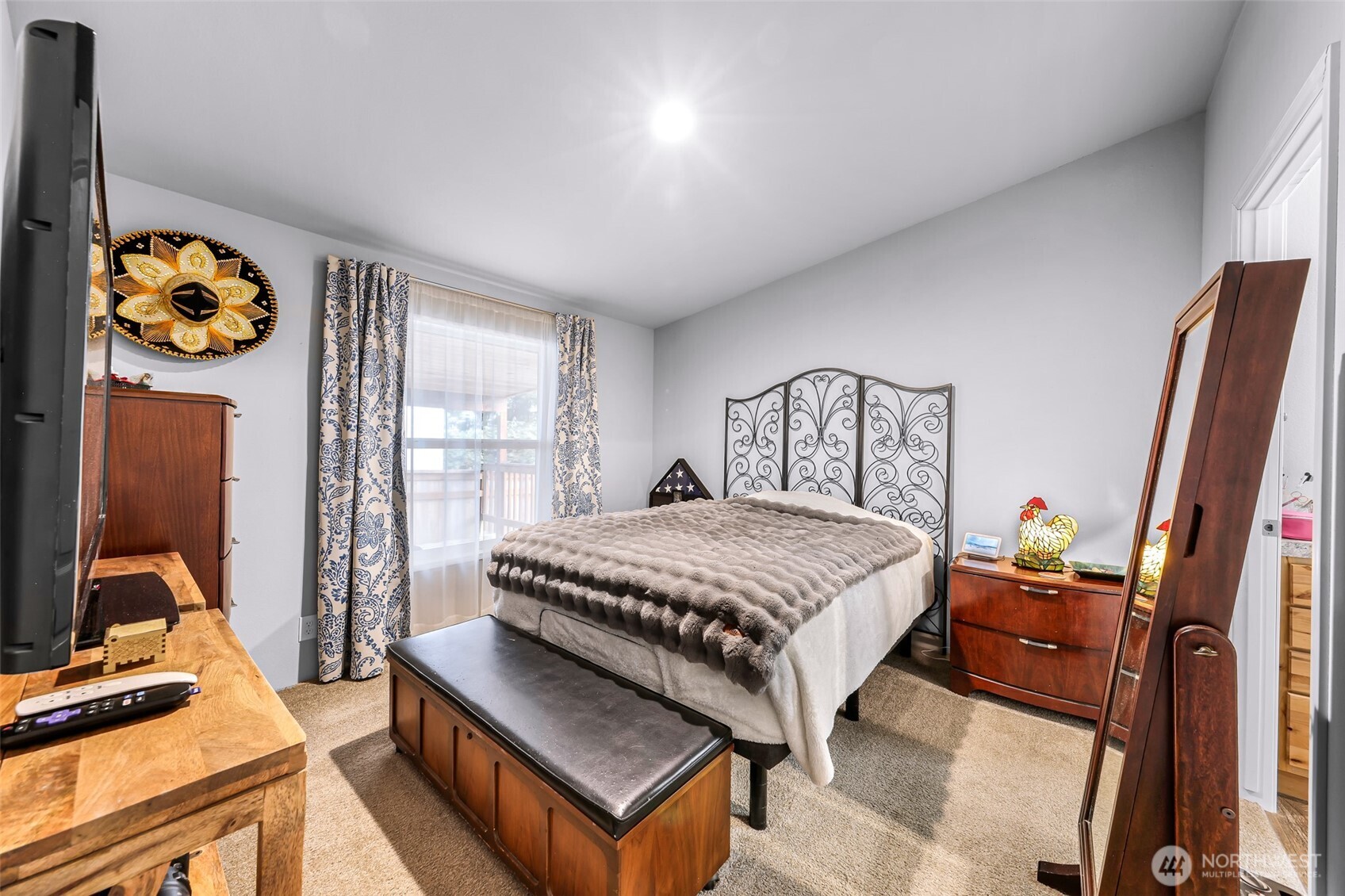 2392 Douglas Road, Unit 57 Ferndale, WA 98248 - Photo 18 of 26 a bedroom with a bed and a flat tv screen on the table