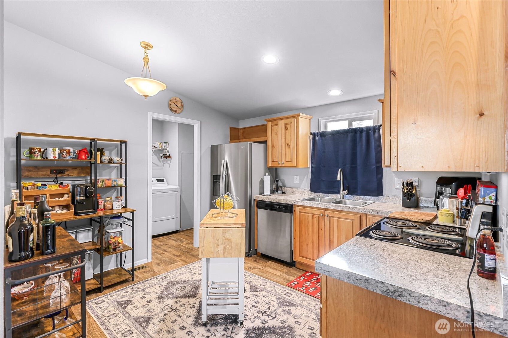 2392 Douglas Road, Unit 57 Ferndale, WA 98248 - Photo 10 of 26 a kitchen with stainless steel appliances granite countertop a sink counter space and cabinets