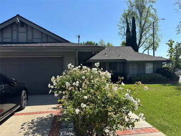 a kitchen with stainless steel appliances granite countertop a refrigerator a sink dishwasher a stove a washer and dryer