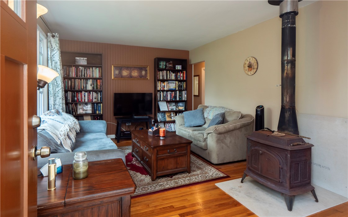 44 Stage Coach Road Portsmouth, RI 02871 - Photo 4 of 45 Living room with hardwood floors and wood burning stove.