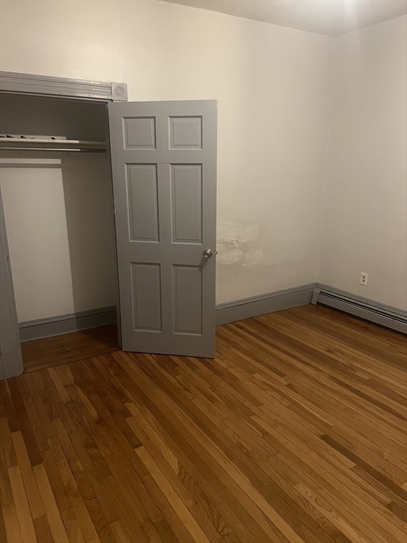 4 Herbert Street, Unit 2 Boston, MA 02124 - Photo 6 of 12 a view of empty room with wooden floor