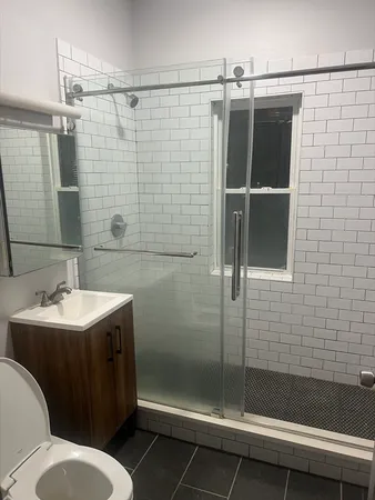 a bathroom with a sink toilet and shower