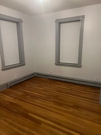a view of a room with wooden floor and cabinet