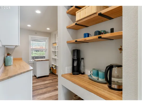 a kitchen view with granite countertop a sink a stove and wooden cabinets