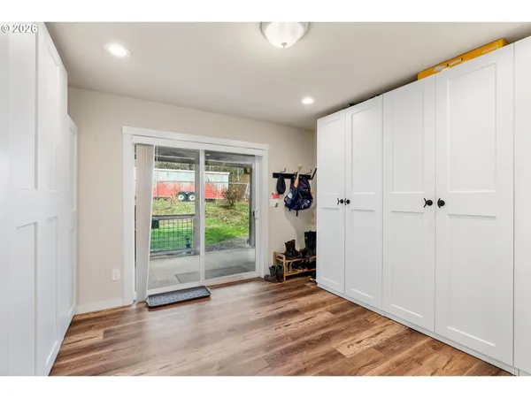 a view of empty room with wooden floor
