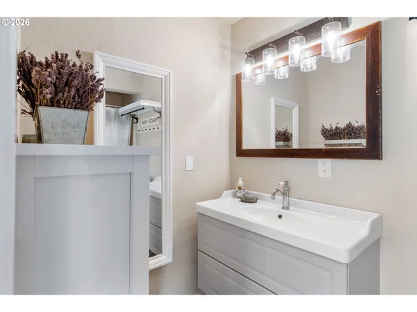 a bathroom with a sink mirror and vanity