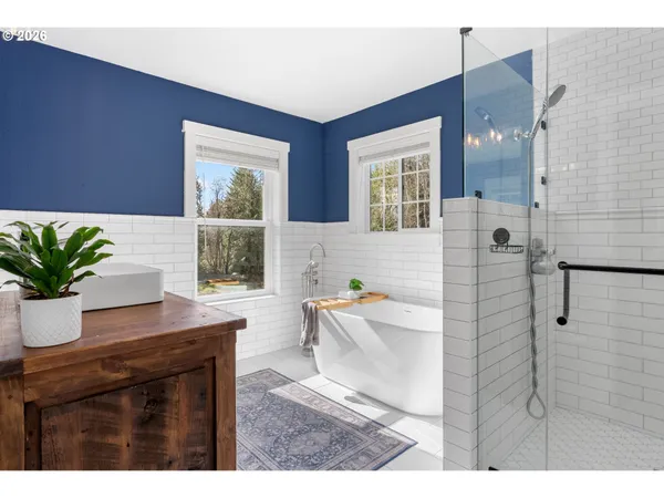 a living room with a couch and a potted plant