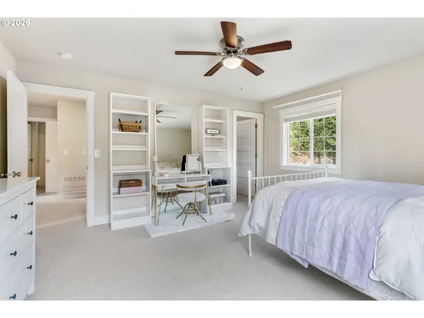 a bed room with a bed and a chair